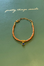 Load image into Gallery viewer, Single Strand Peach Colored Freshwater Pearl Bracelet with Sapphire Colored Crystal Charm and Paperclip Adjustable Chain
