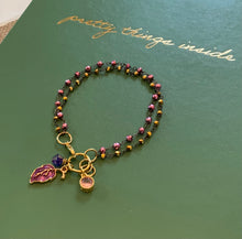 Load image into Gallery viewer, Double Strand 14Kt. Gold and Light Garnet Beads in Black Wire Wrapped chain with Ruby Colored Leaf Charm, Amethyst Swarovski Crystal and Pink Round Charms

