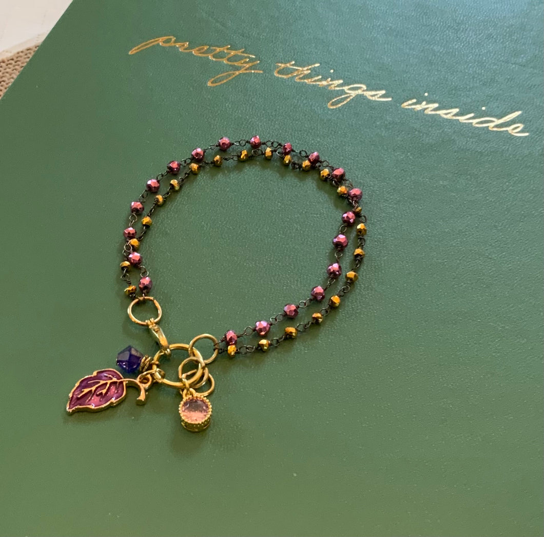 Double Strand 14Kt. Gold and Light Garnet Beads in Black Wire Wrapped chain with Ruby Colored Leaf Charm, Amethyst Swarovski Crystal and Pink Round Charms